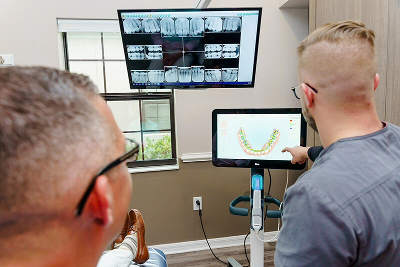 Dentist explaining to a patient - Dental Implants in St. Petersburg, FL