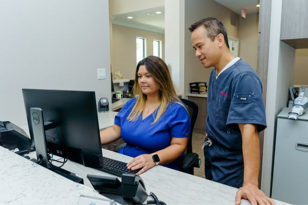 dentist looking at computer