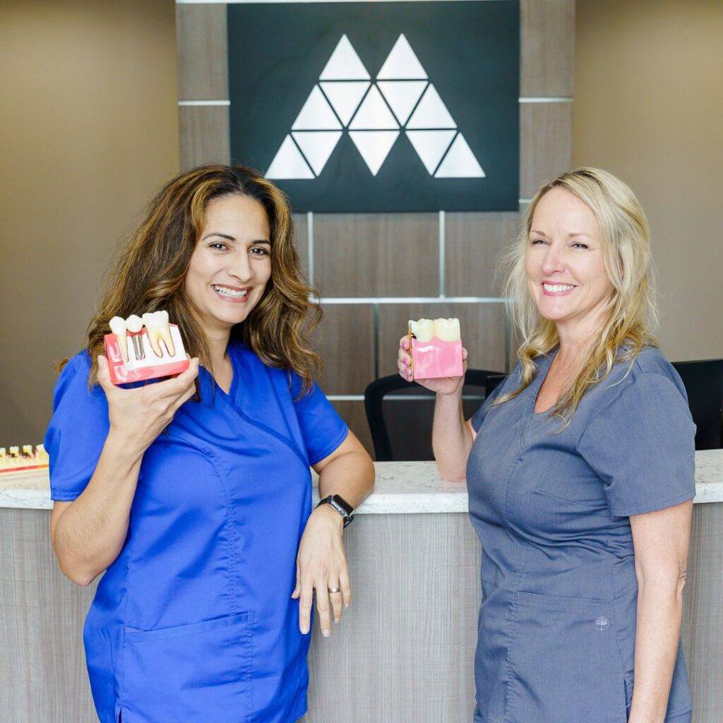 Assistants showing different dental implants options