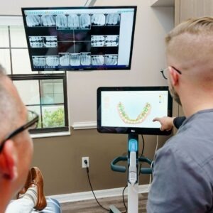 a dentist reviewing dental records with patient
