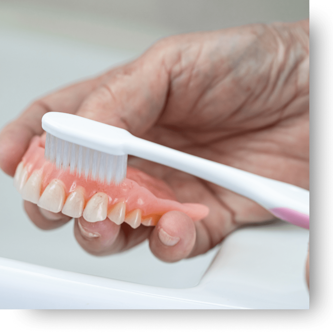 brushing dentures