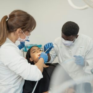 Two dentist working on a patient