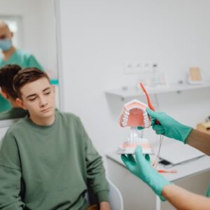 A teen speaking to their dentist